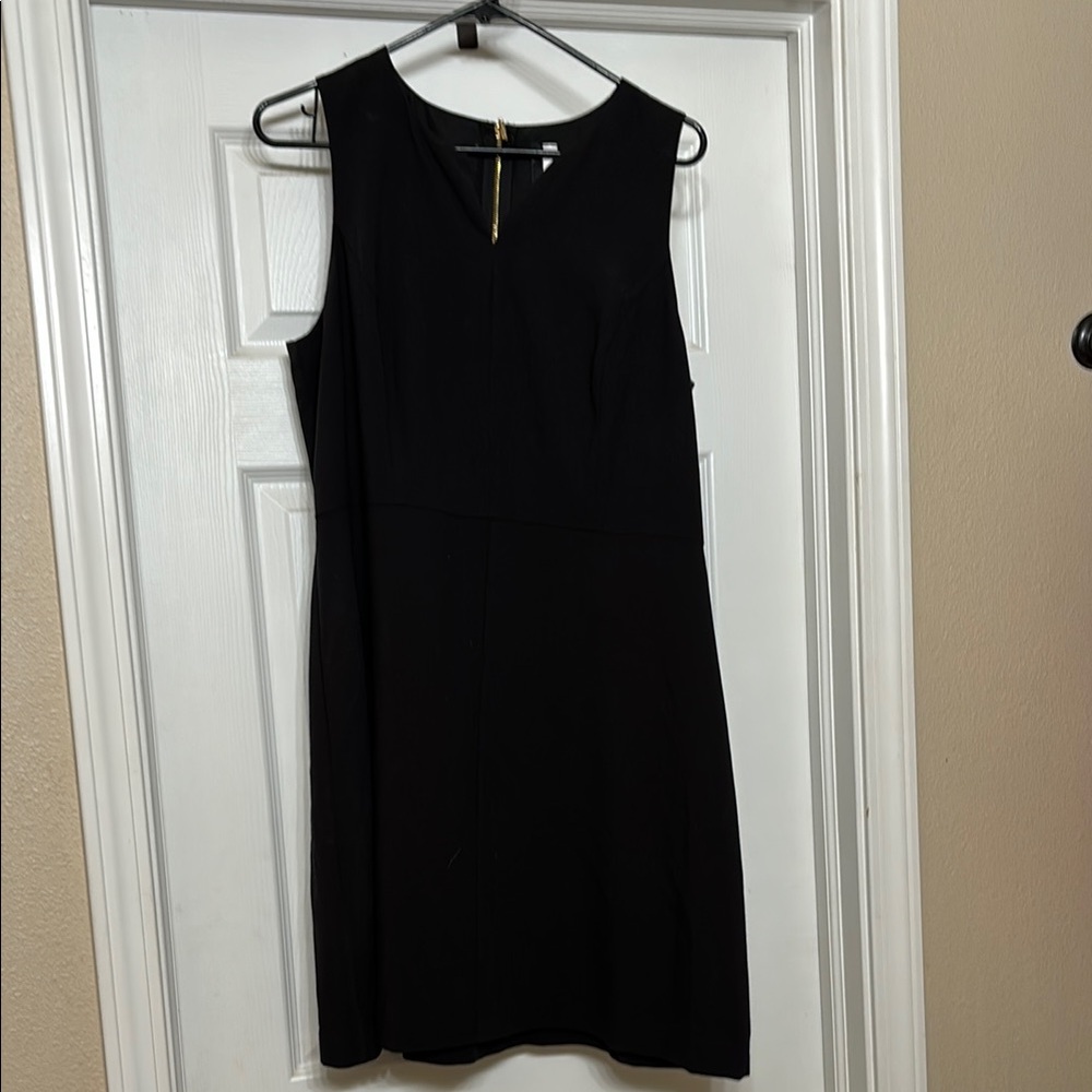 Knee length little black dress with gold accent zipper